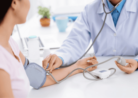 Woman having her blood pressure measured