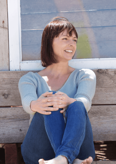 Happy woman relaxing on a bench Happy woman relaxing on a bench