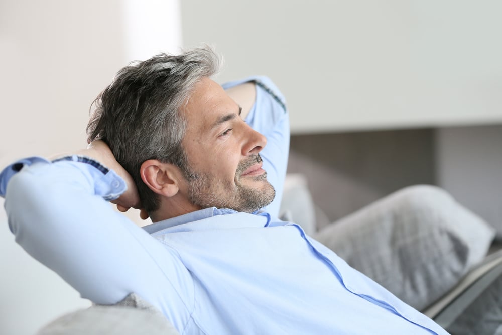 Middle-aged man having a restful moment relaxing in sofa Middle-aged man having a restful moment relaxing in sofa