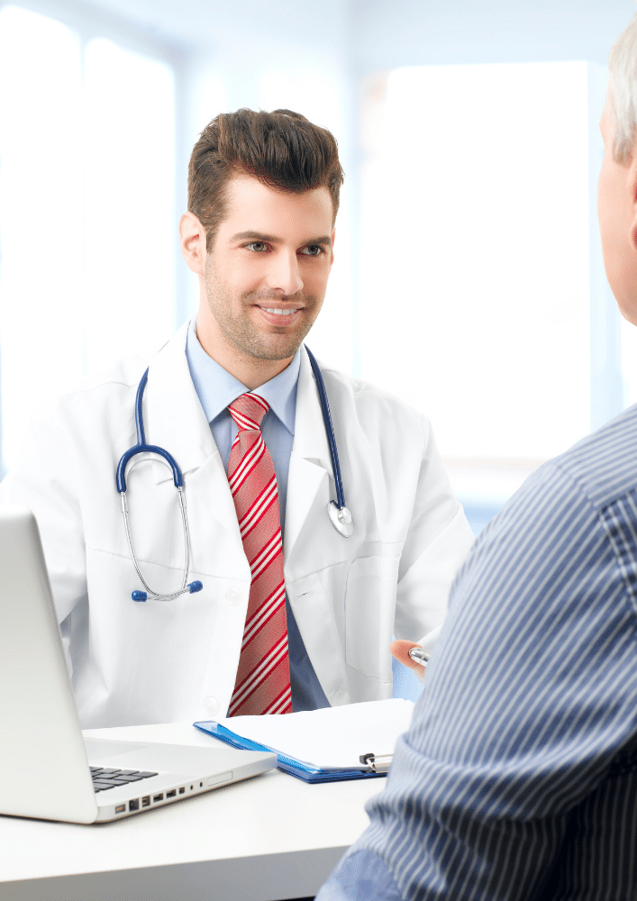 Young male doctor speaking with patient